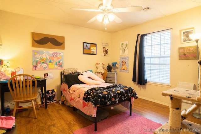 bedroom with hardwood / wood-style flooring and ceiling fan