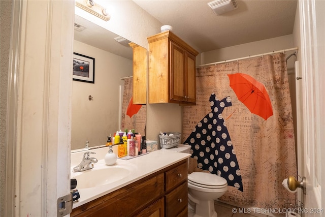 bathroom with curtained shower, vanity, a textured ceiling, and toilet