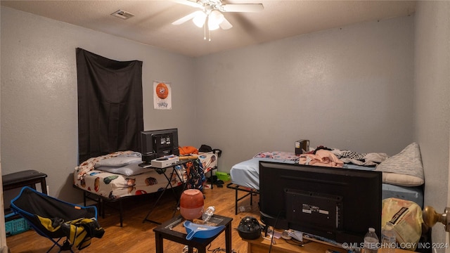 bedroom featuring hardwood / wood-style floors and ceiling fan