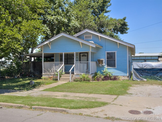 bungalow-style house featuring a front lawn and a porch