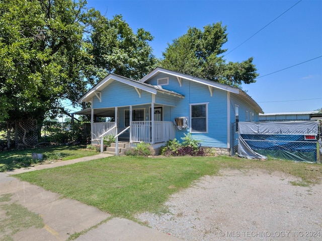 bungalow with a porch and a front yard