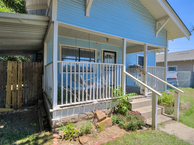 view of exterior entry with a porch