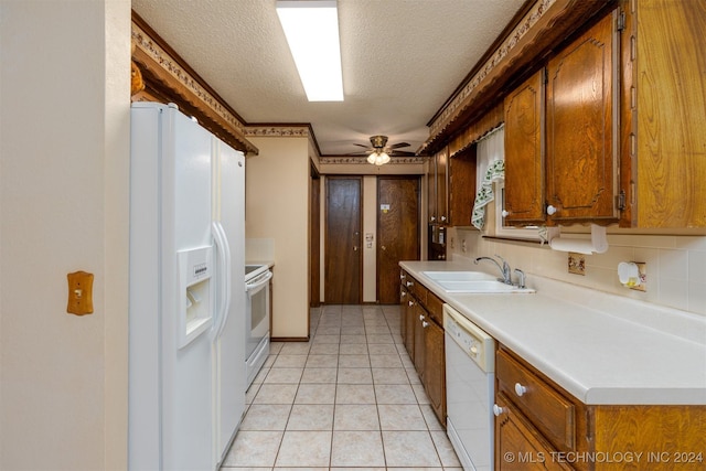 kitchen with ceiling fan, sink, tasteful backsplash, a textured ceiling, and white appliances