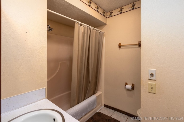 bathroom with tile patterned floors, sink, shower / tub combo, and a textured ceiling