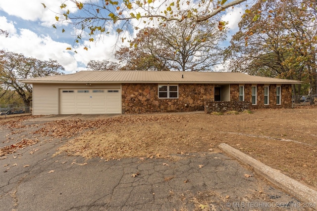 single story home featuring a garage