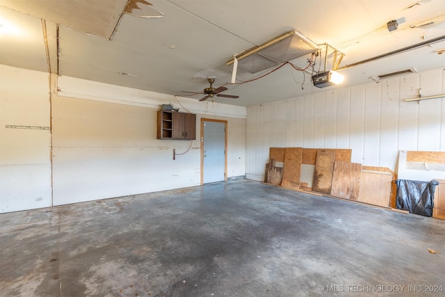 garage with a garage door opener and ceiling fan