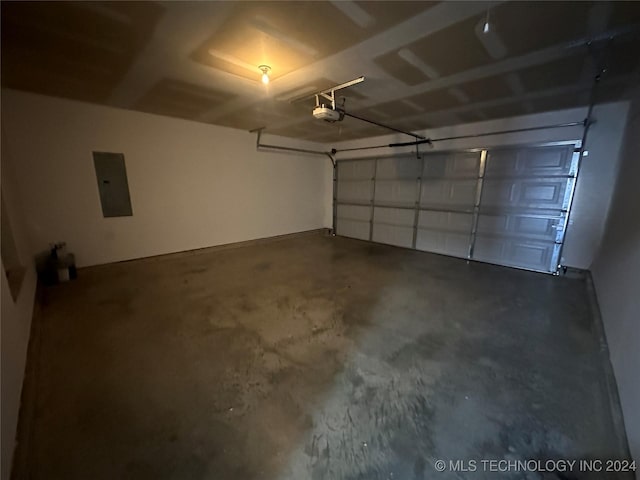 garage with electric panel and a garage door opener