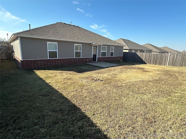 rear view of house with a lawn