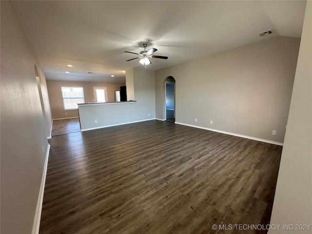 unfurnished living room with ceiling fan, dark hardwood / wood-style flooring, and lofted ceiling