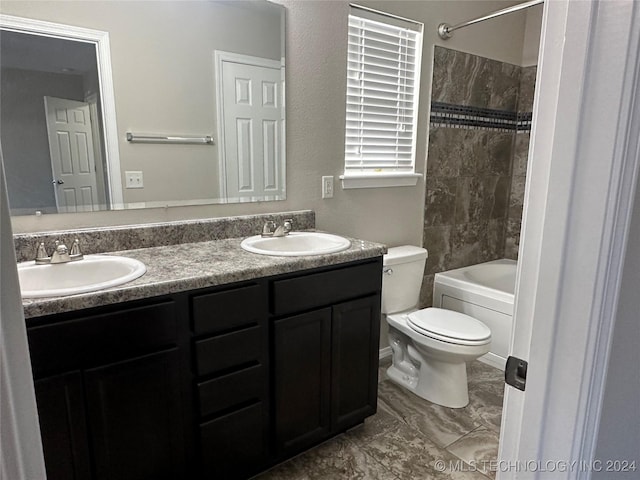 full bathroom featuring vanity, toilet, and tiled shower / bath combo