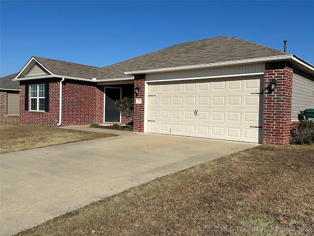 ranch-style home featuring a garage and a front lawn