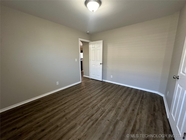 empty room featuring dark hardwood / wood-style flooring