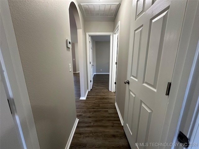 hallway with dark hardwood / wood-style floors