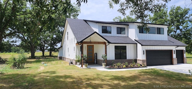 modern inspired farmhouse with a garage and a front yard