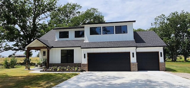 modern farmhouse style home with a garage and a front lawn