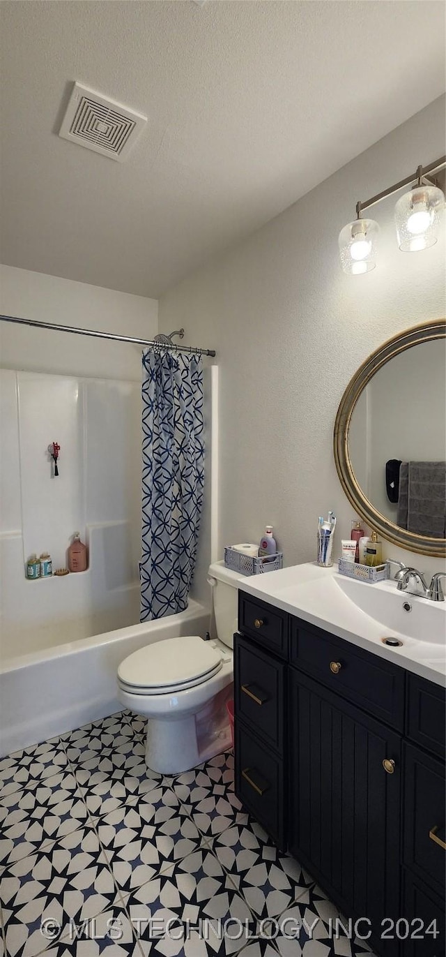 full bathroom with vanity, toilet, shower / bathtub combination with curtain, and a textured ceiling