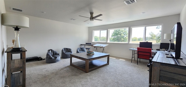 carpeted living room with ceiling fan