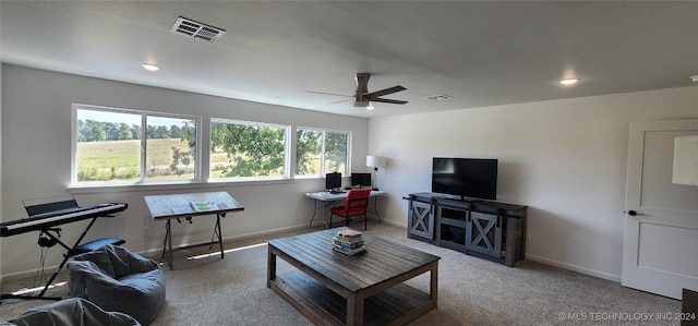 carpeted living room with ceiling fan