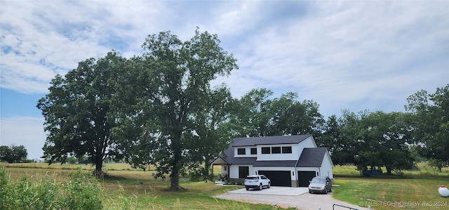 view of front facade with a front lawn and a garage