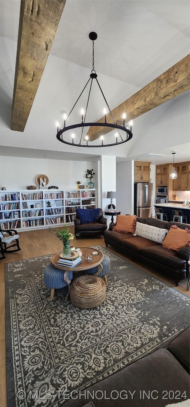 living room with beam ceiling, hardwood / wood-style flooring, and a notable chandelier