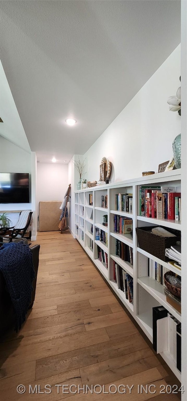 hallway with hardwood / wood-style flooring