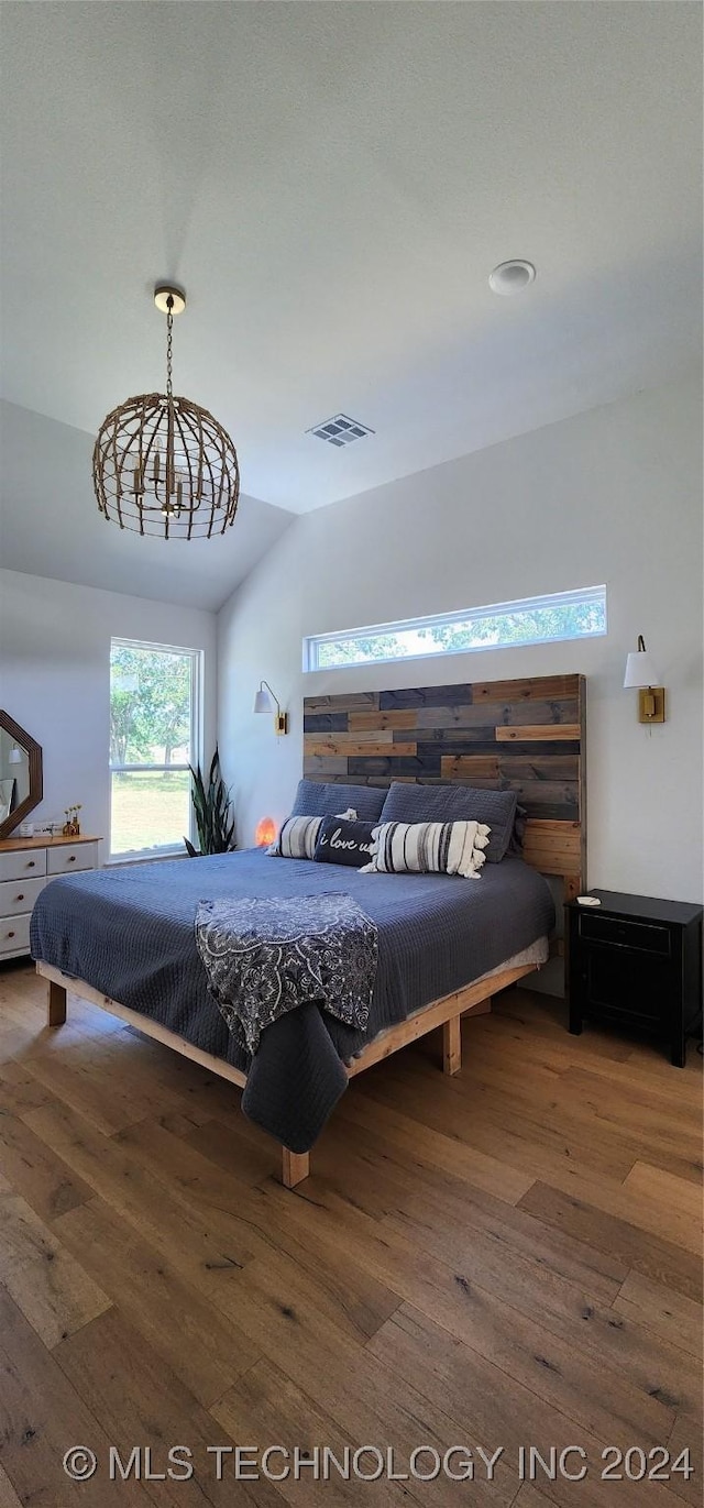 bedroom featuring vaulted ceiling and dark wood-type flooring