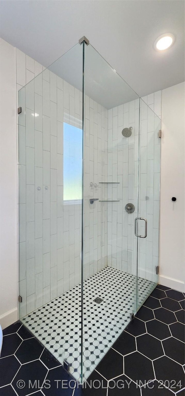 bathroom with a shower with shower door