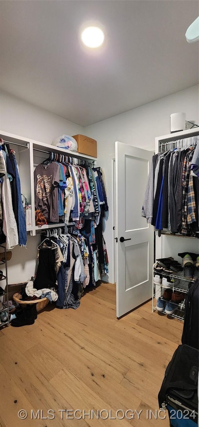 spacious closet featuring hardwood / wood-style floors