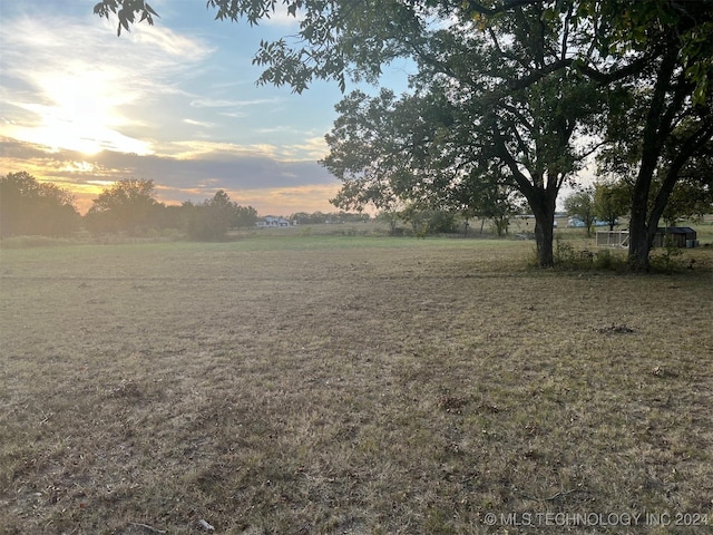 yard at dusk with a rural view