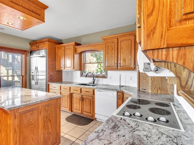 kitchen with dishwasher, sink, stainless steel fridge, light tile patterned floors, and electric stovetop