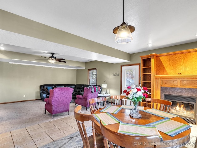 carpeted dining space featuring ceiling fan and a textured ceiling