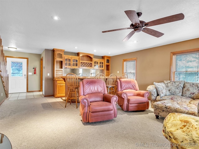 living room featuring light carpet and ceiling fan