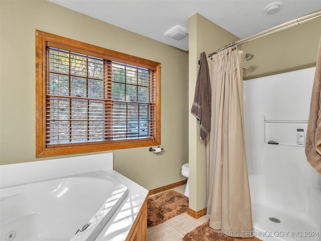 bathroom with tile patterned floors and shower with separate bathtub