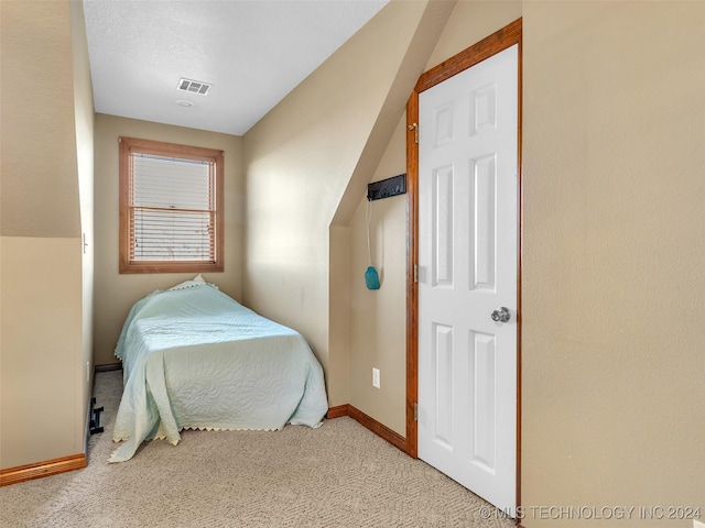 carpeted bedroom featuring a textured ceiling