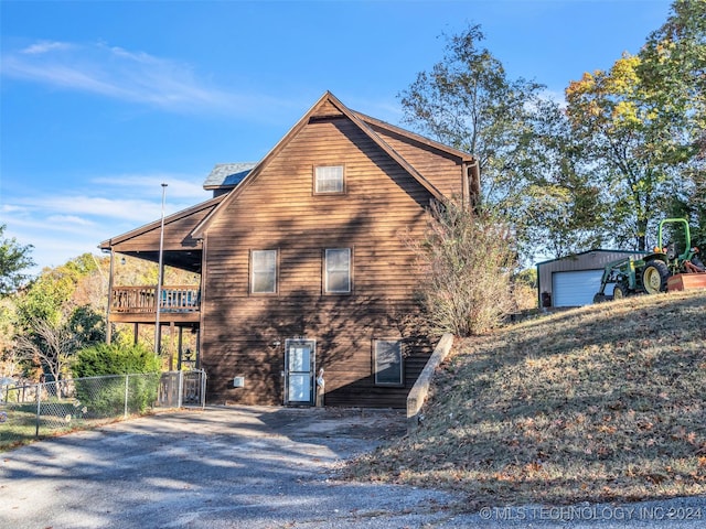 view of side of property with an outdoor structure and a garage