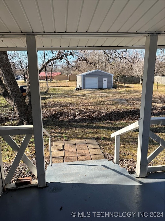 view of yard featuring a patio area, an outdoor structure, and a garage