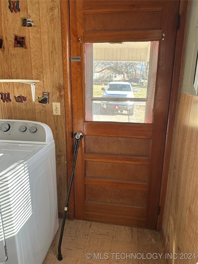 laundry area featuring washer / clothes dryer and wood walls