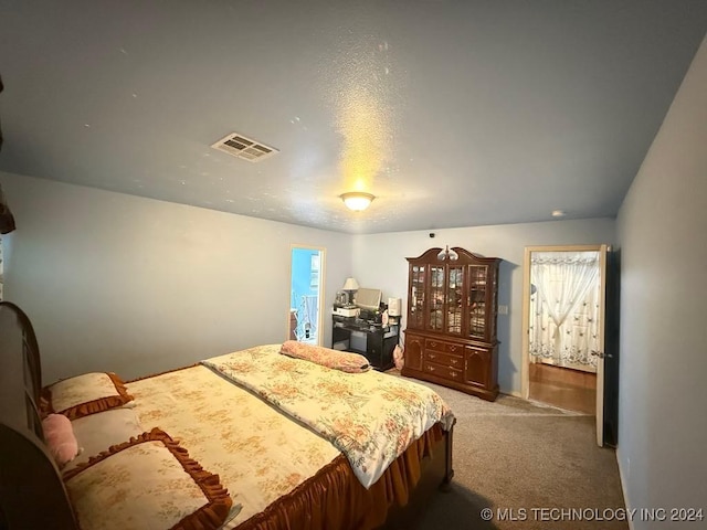 bedroom featuring a textured ceiling and carpet