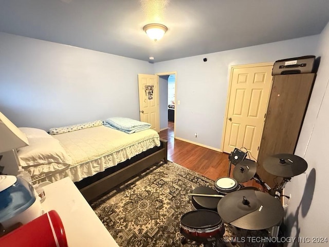 bedroom with dark hardwood / wood-style floors