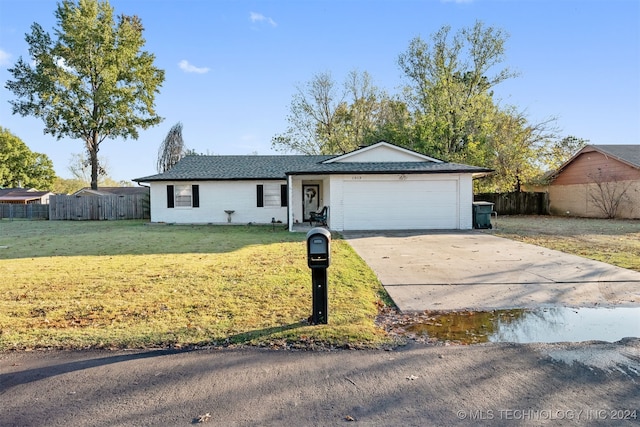 ranch-style house with a front yard and a garage