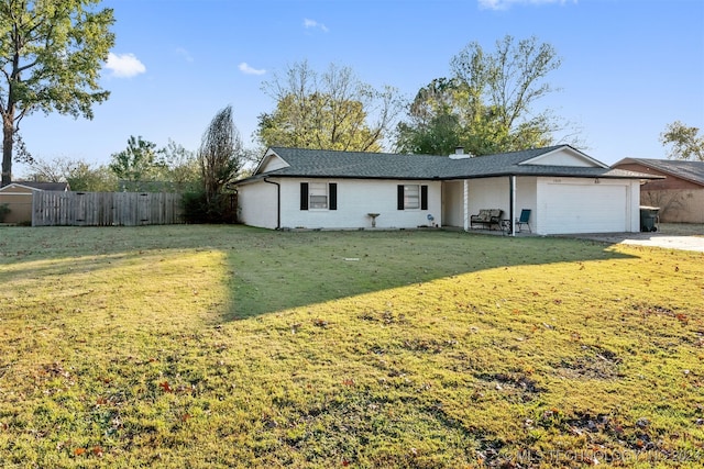 ranch-style home with a front yard and a garage