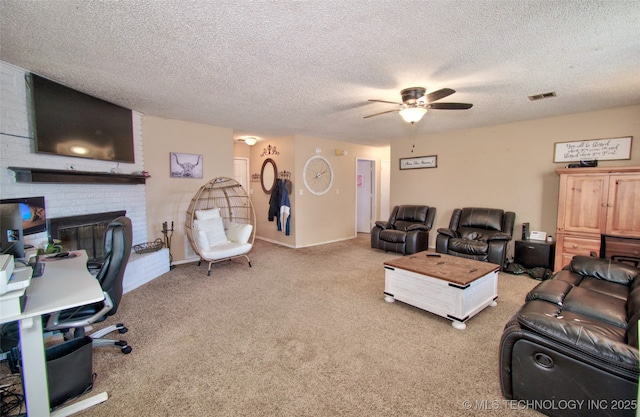 carpeted living room featuring a textured ceiling, ceiling fan, and a fireplace