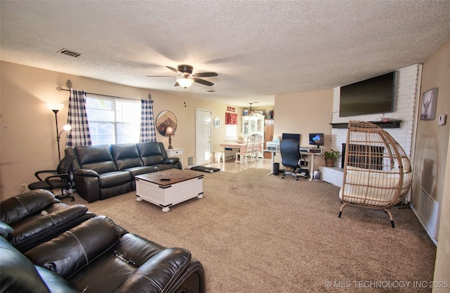 living room with a textured ceiling and ceiling fan