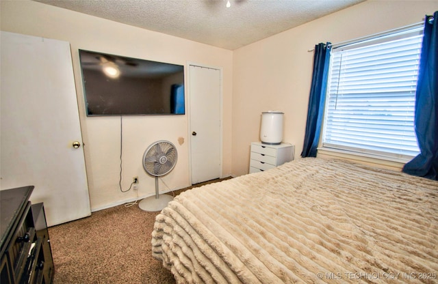 bedroom featuring a textured ceiling and carpet