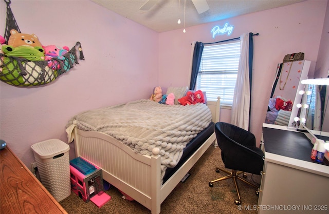 bedroom with ceiling fan, a textured ceiling, and carpet flooring