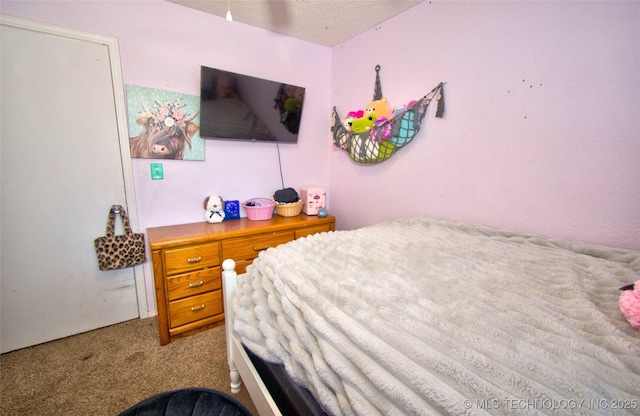 carpeted bedroom featuring a textured ceiling