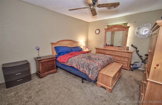 bedroom featuring ceiling fan, a textured ceiling, and carpet flooring