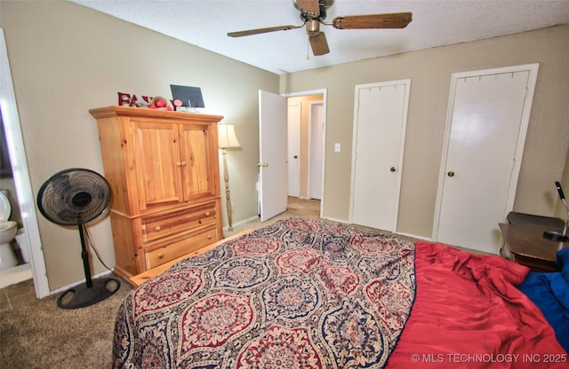 bedroom featuring multiple closets, ceiling fan, and light colored carpet