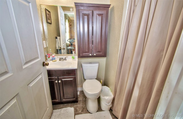 bathroom with toilet and vanity