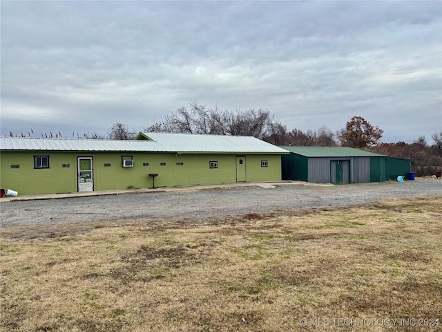 rear view of property with an outbuilding